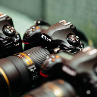 A Nikon camera sitting on a product shelf next to other cameras